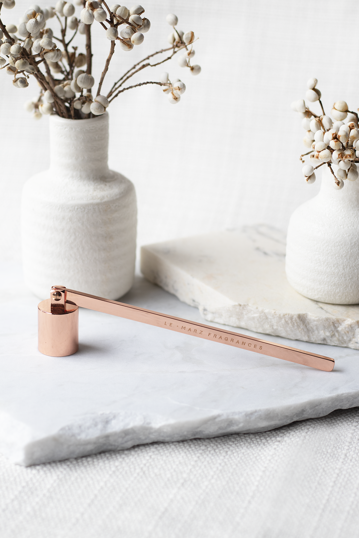 Champagne Rose Gold coloured candle snuffer for candle care.