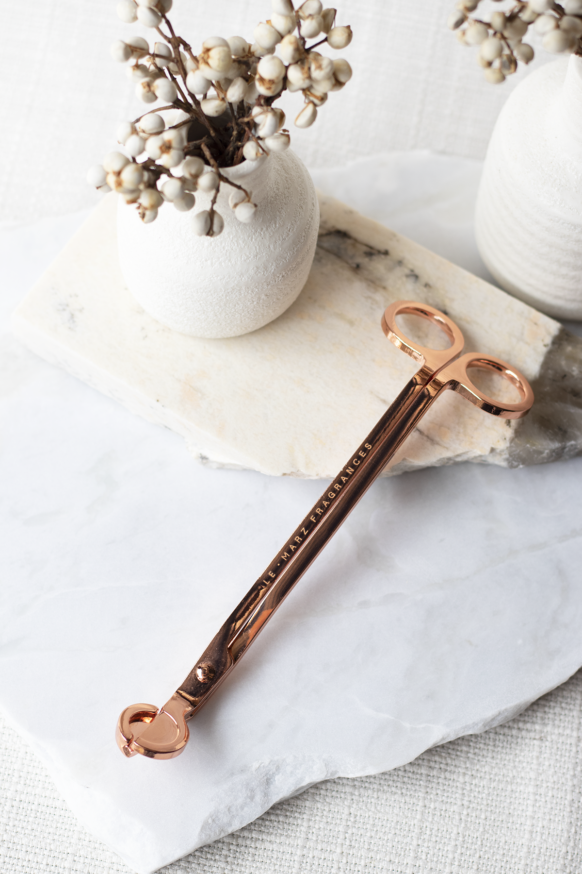 Champagne Rose Gold coloured wick trimmer for candle care.