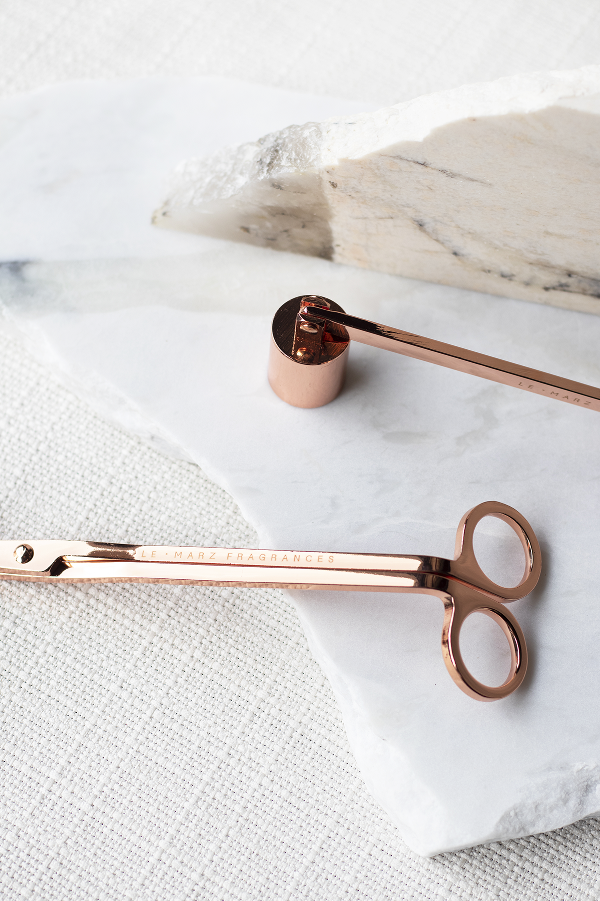 Champagne Rose Gold coloured wick trimmer and candle snuffer for candle care.